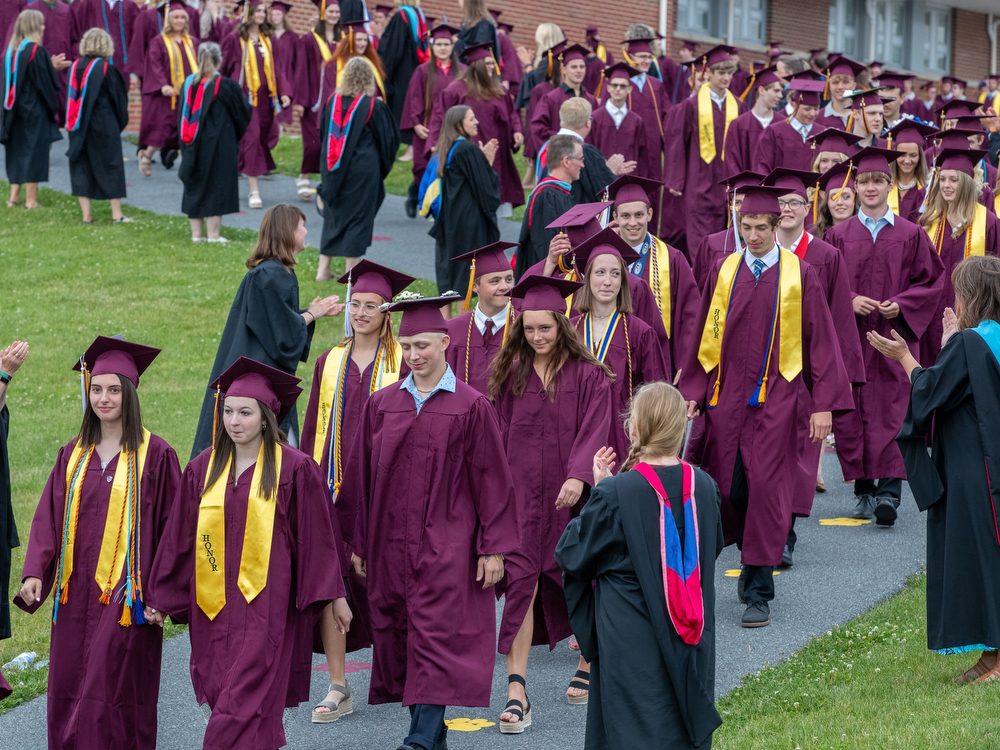 Big Spring seniors walk to their 2022 Big Spring High School Commencement, between rows of their teachers, in Newville, Pa., June 10, 2022.
Mark Pynes | pennlive.com
